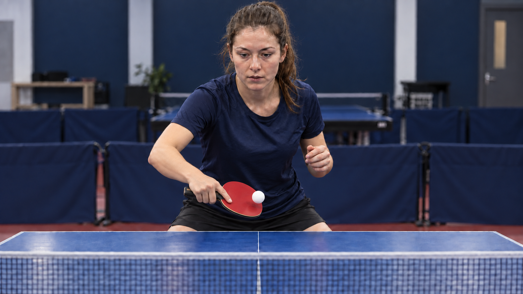 Frontal view of a player practicing an open-face backhand push